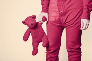 Sticking With Bedtime Routines 1 child holding teddy bear before bedtime