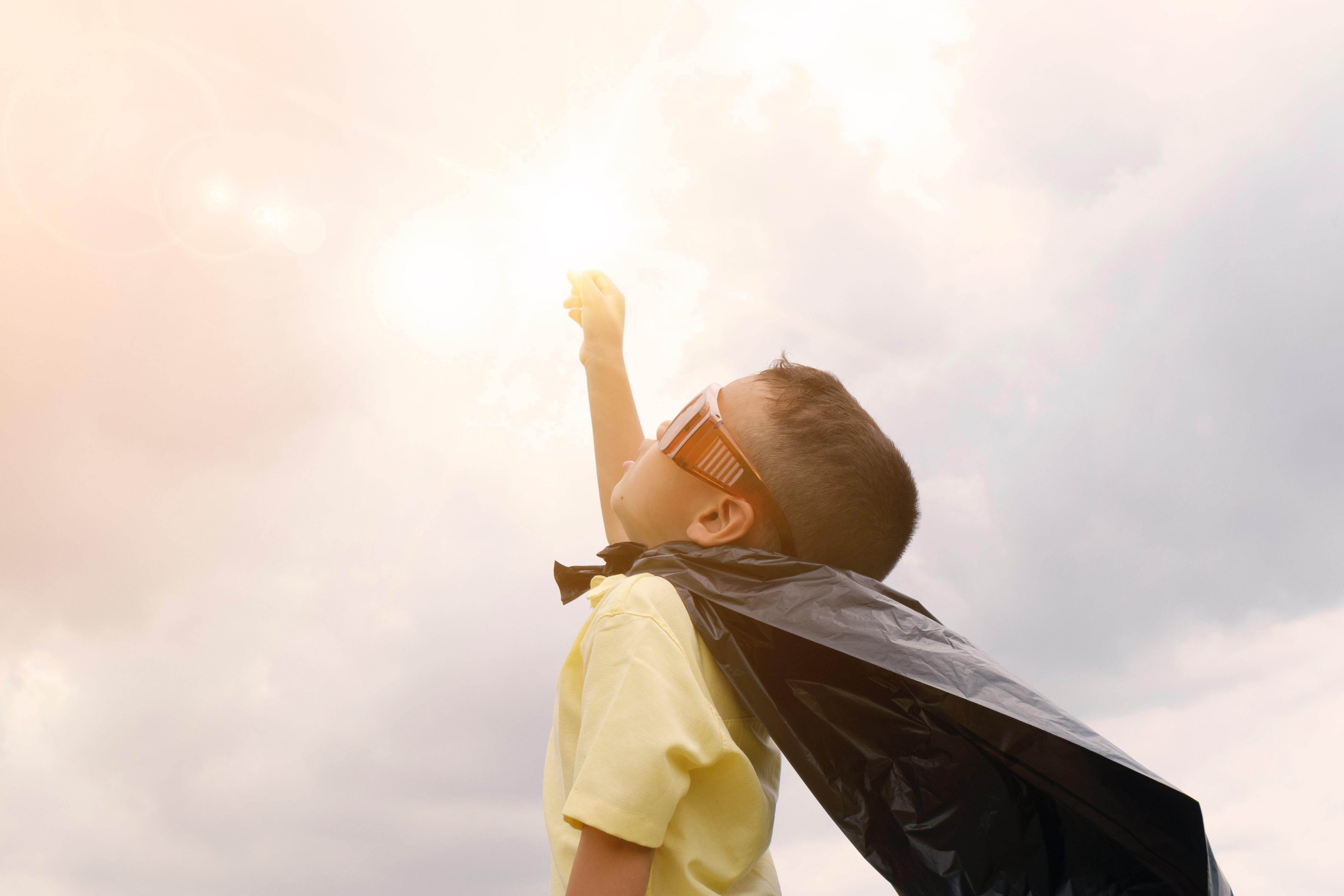 child wearing a cape