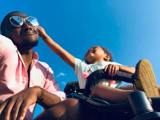 father and child enjoying the sun