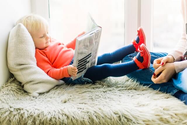 little baby reading a book