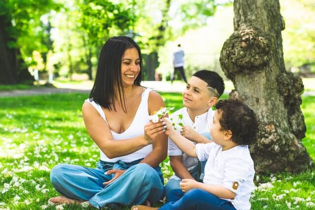 mother sitting with 2 kids