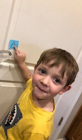 boy pointing at a triangle