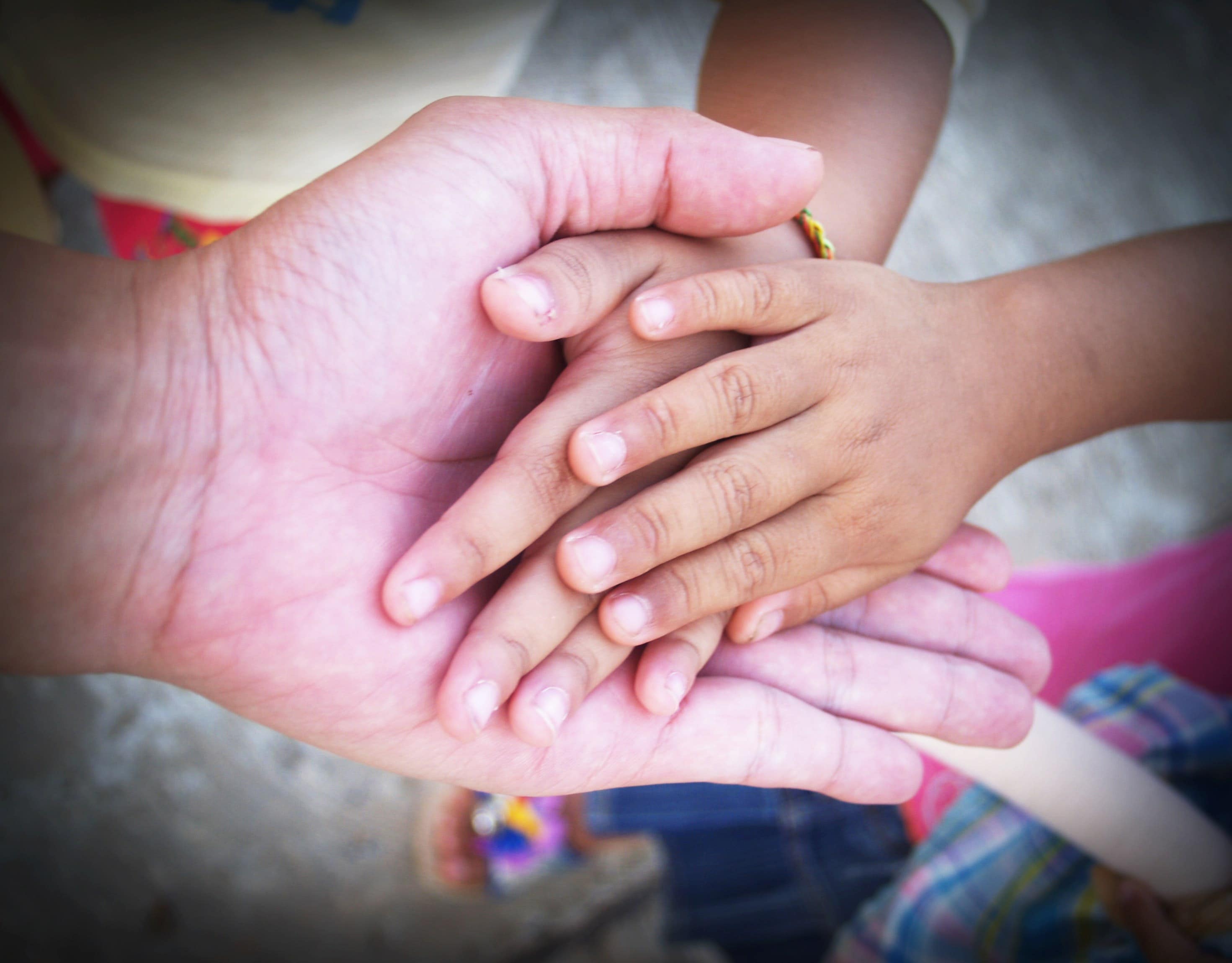 adult and child holding hands