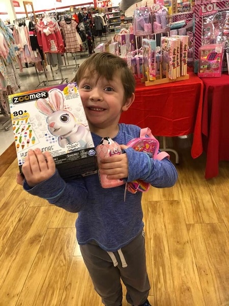 kid carrying toys